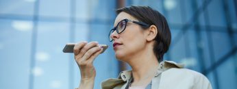 Businesswoman recording voice message