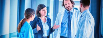 Businesswoman talking with doctors