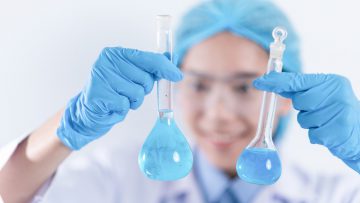 scientist with equipment and science experiments, laboratory glassware containing chemical liquid